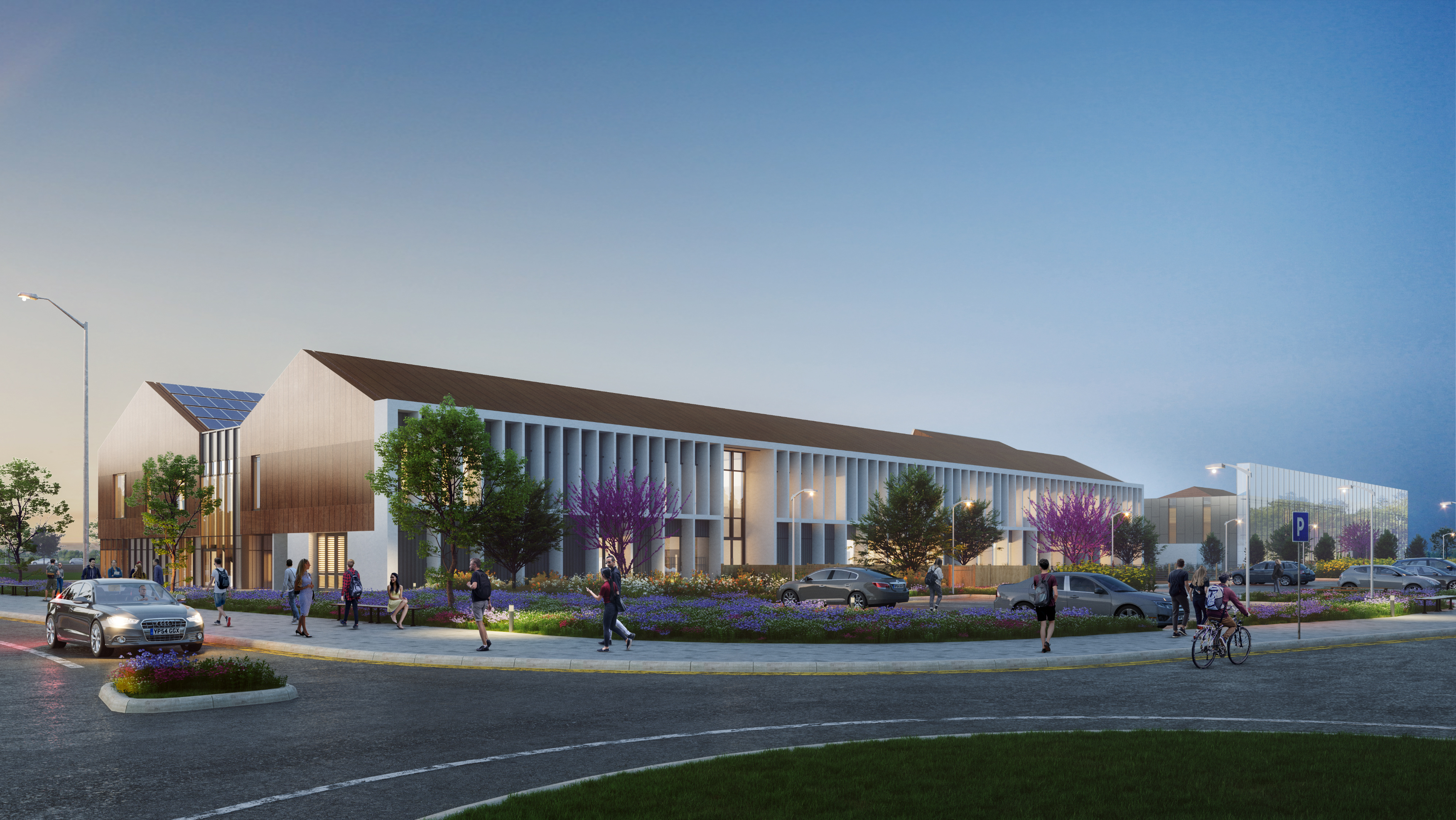 A vibrant university campus with people walking, cycling and driving around