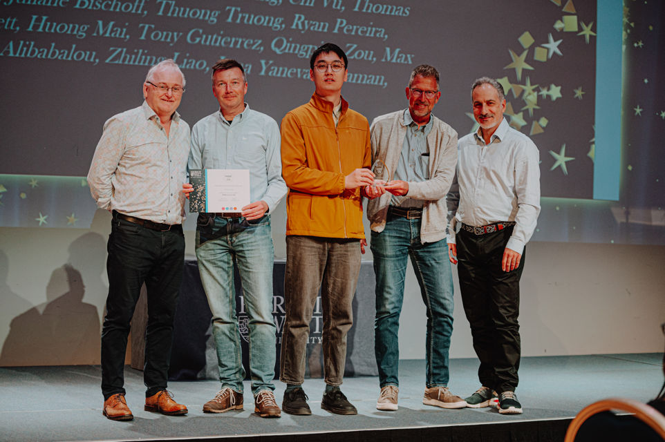 4 people receiving an award from the Vice Principal