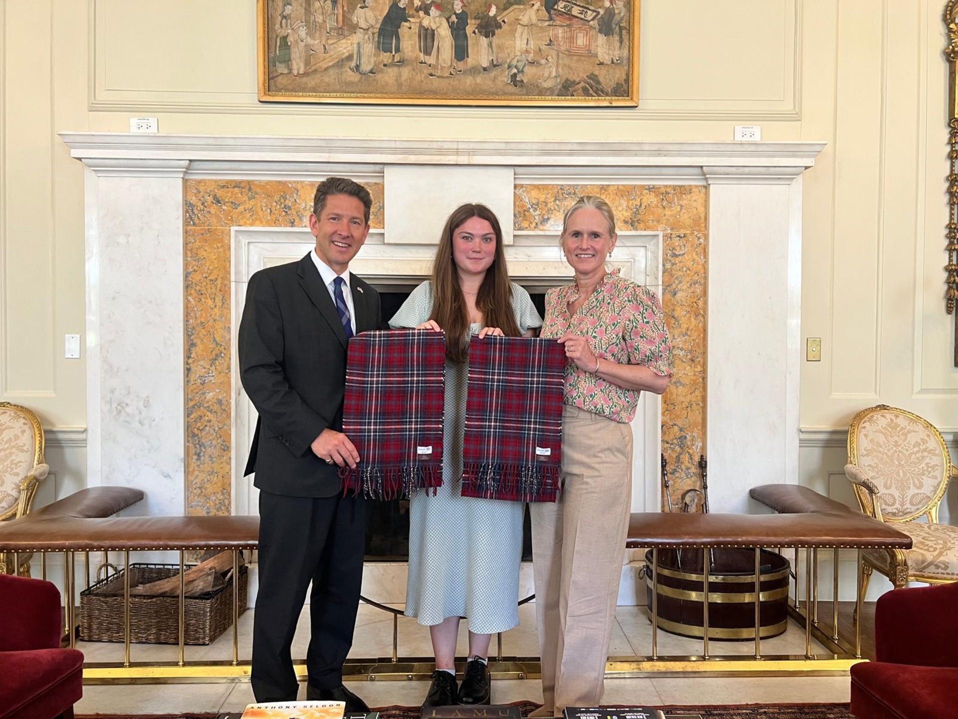Kaci presenting the tartan to the British Ambassador Sir Christian Turner and his wife Lady Turner