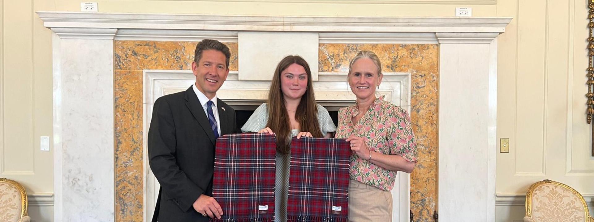 Kaci presenting the tartan to the British Ambassador Sir Christian Turner and his wife Lady Turner