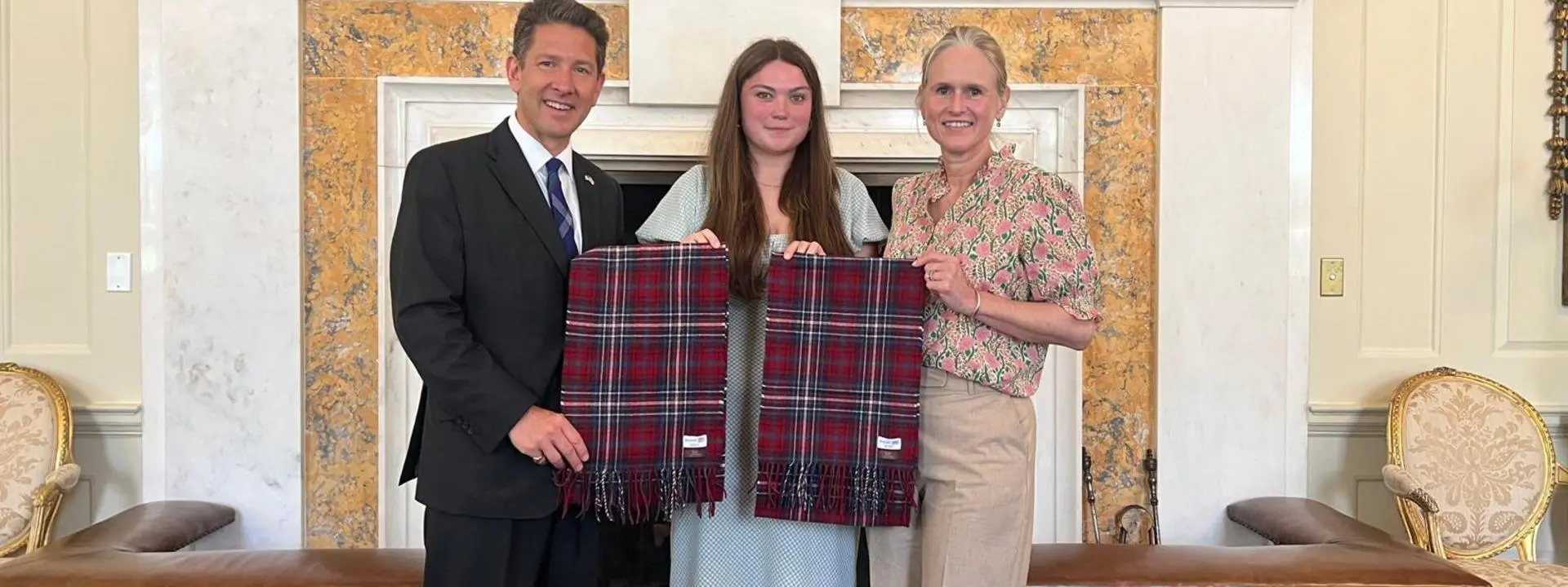 Kaci presenting the tartan to the British Ambassador Sir Christian Turner and his wife Lady Turner