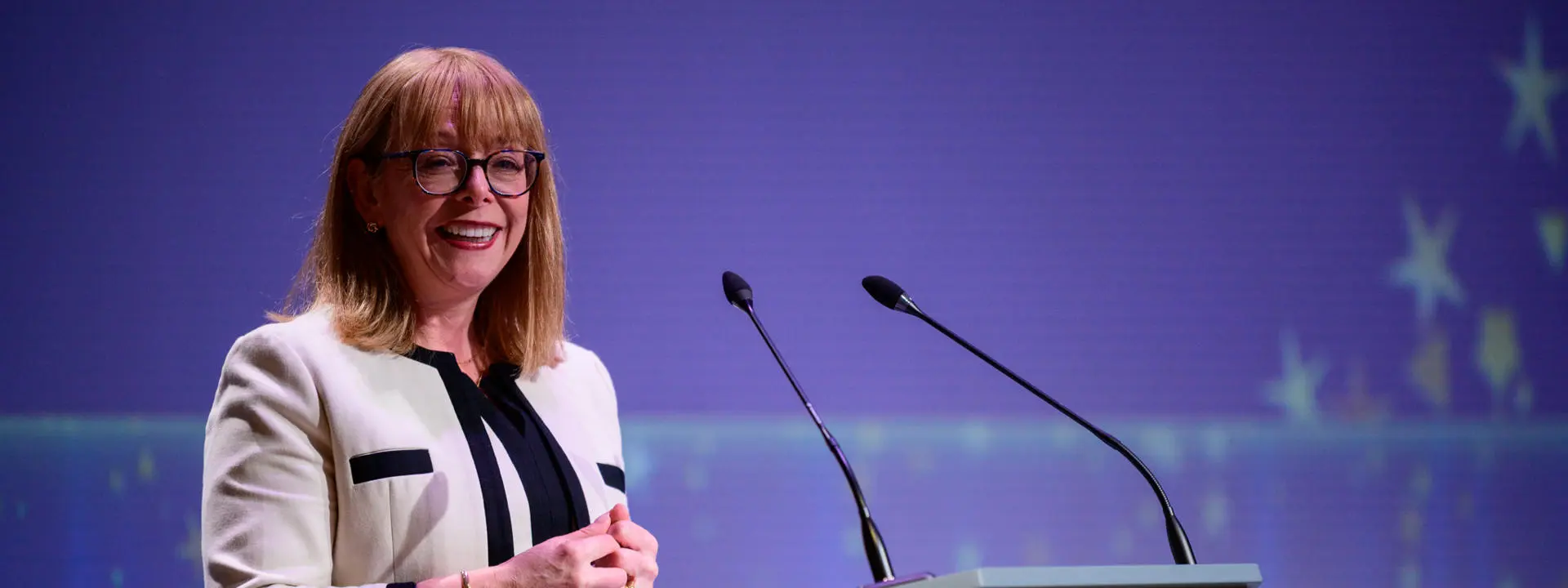 Principal Nola Hewitt-Dundas standing at a podium at Heriot-Watt University