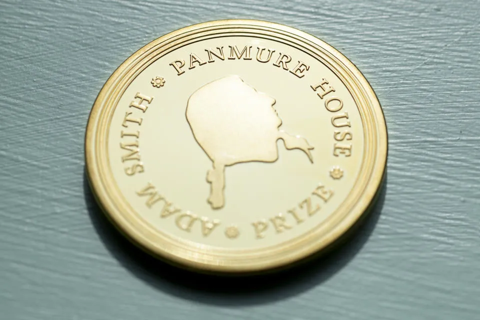 A symbolic gold-plated bronze coin with the profile of Adam Smith is presented to the winner of the Panmure House Prize.