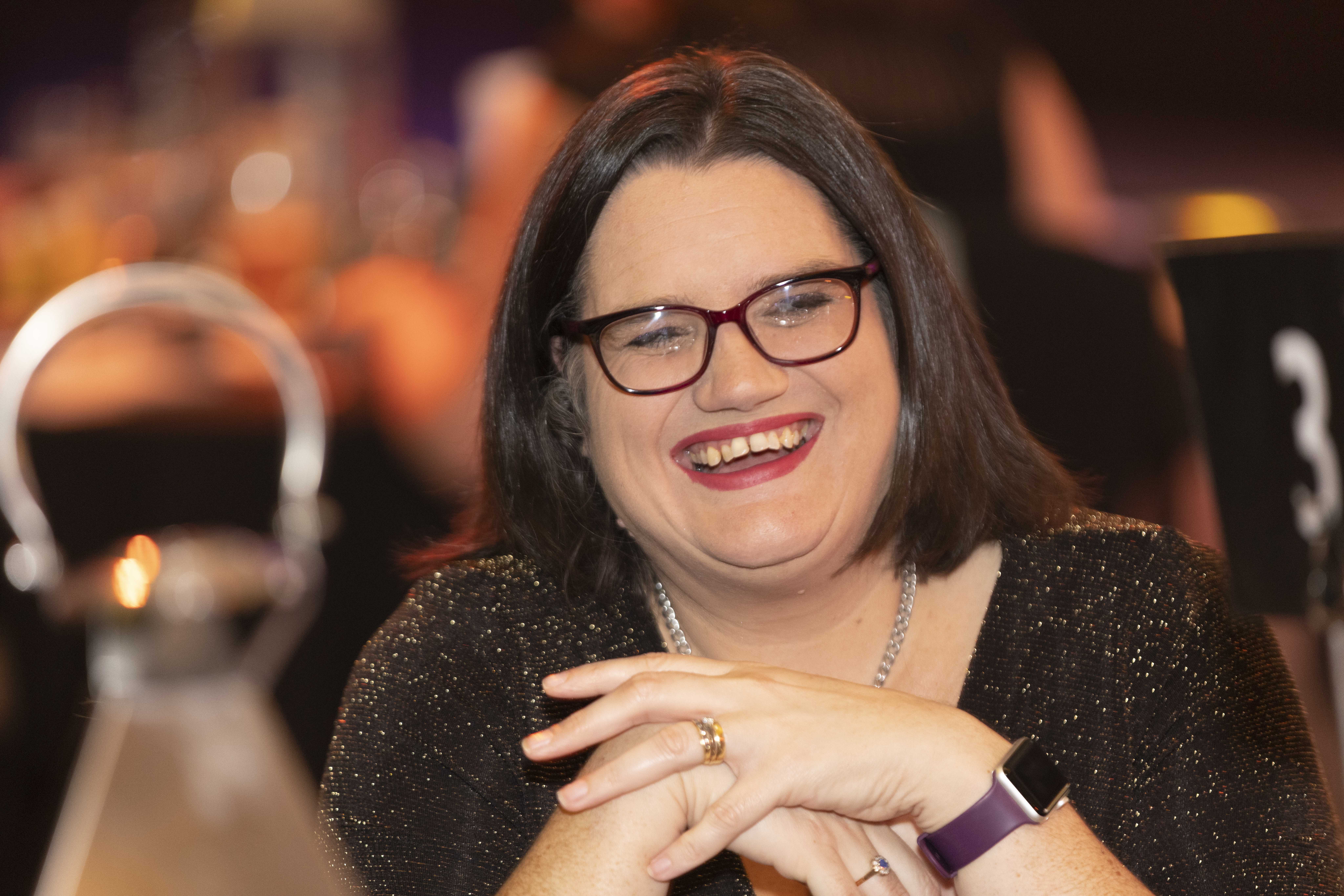 Professor Dawn Maskell pictured sitting at an awards ceremony.