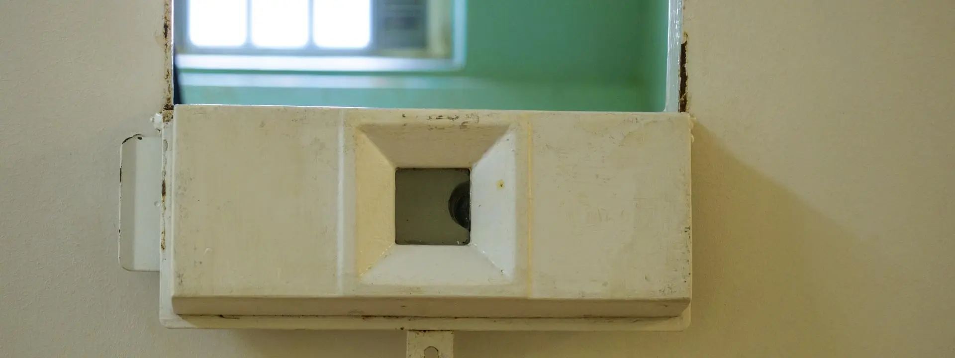 A peep hole on a prison cell door.