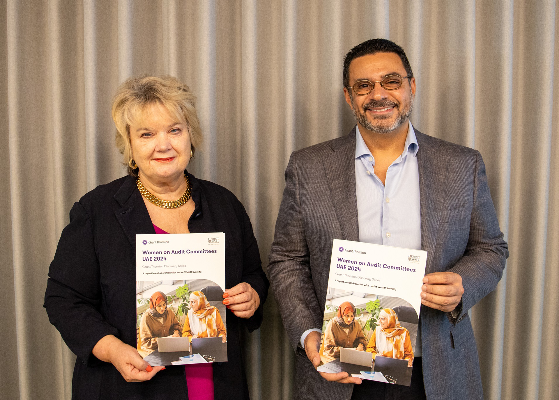 HWUD provost and CEO of Grant Thornton holding physical copy of the report