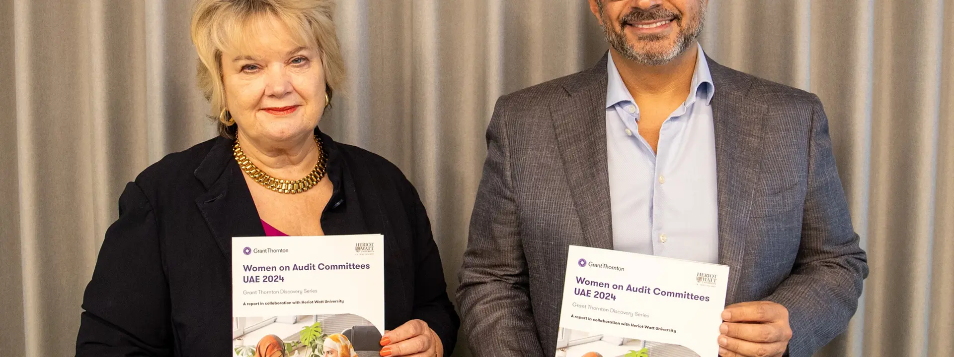 HWUD provost and CEO of Grant Thornton holding physical copy of the report
