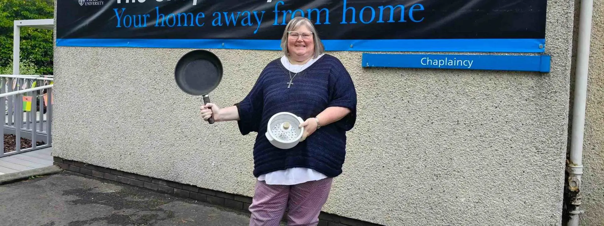 Reverend Jane Howitt pictured holding some of the donated kitchenware.