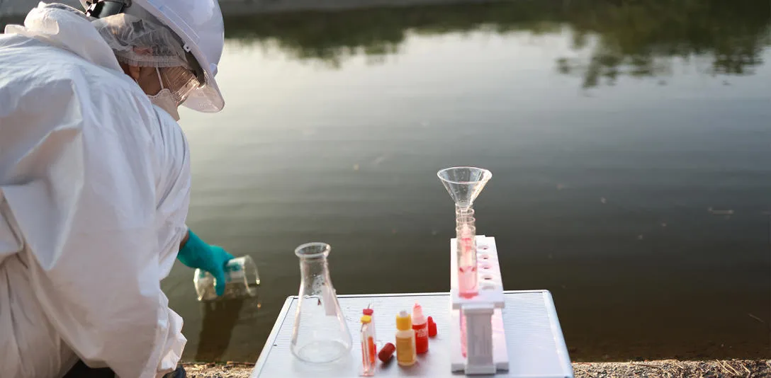 A scientist collecting water samples. A scientist collecting water samples