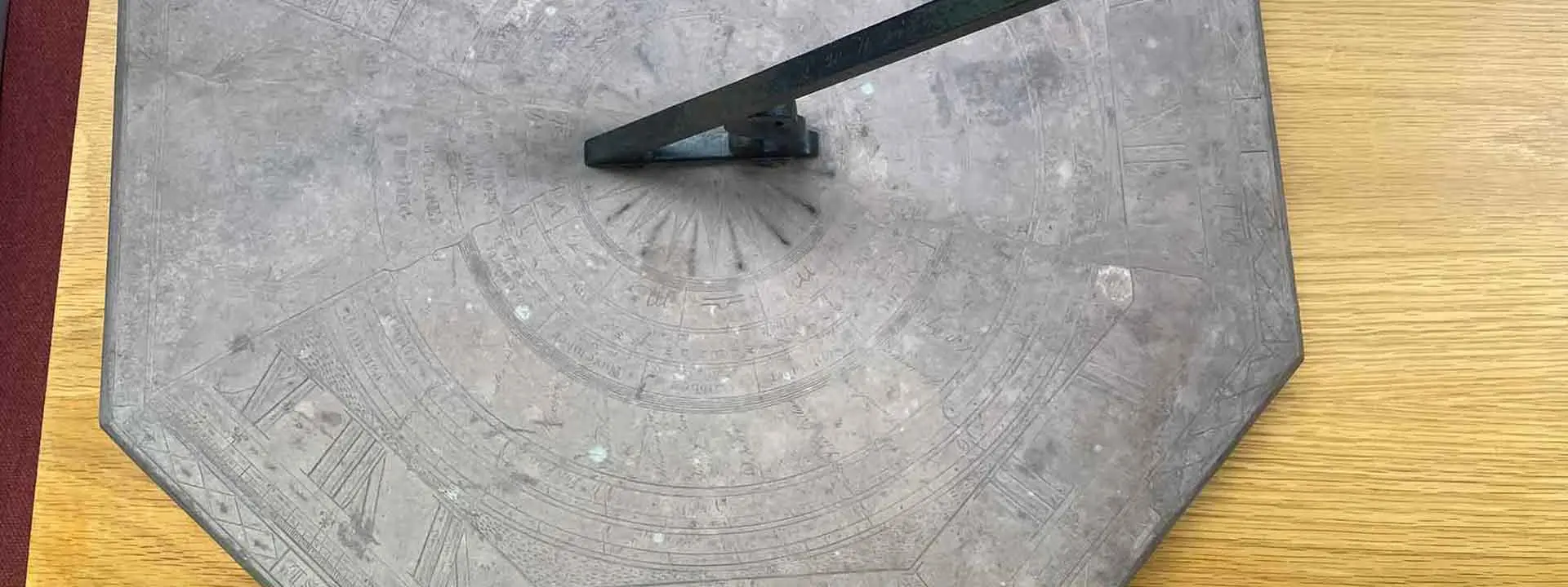 Large octagonal stone sundial with roman numerals and markings