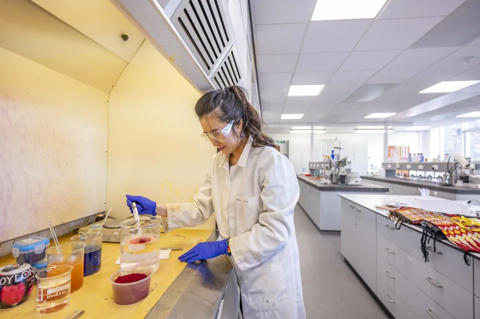 A scientist at work in a lab. A woman scientist at work in a lab