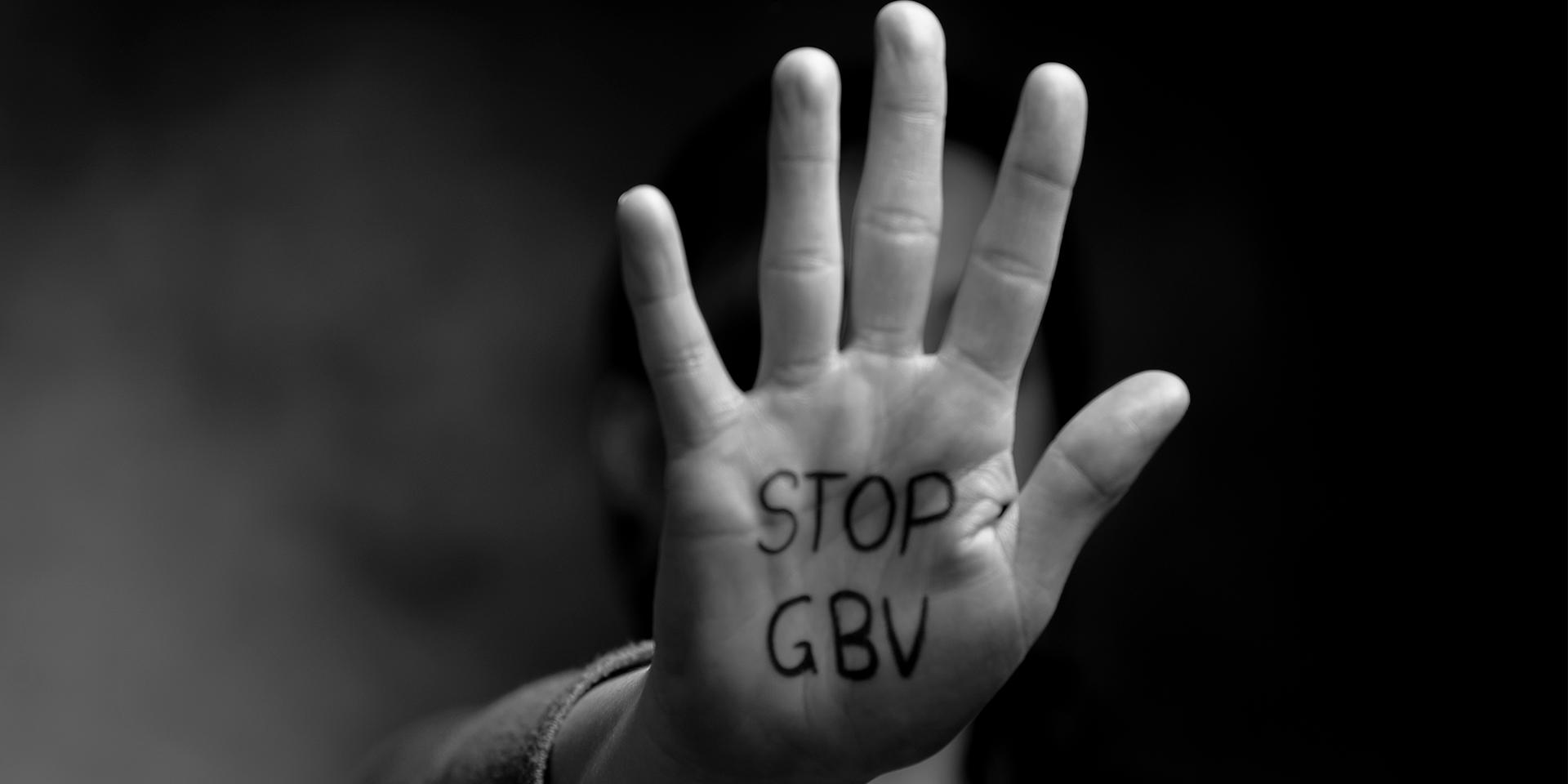 A hand with 'stop now' written on it in marker pen