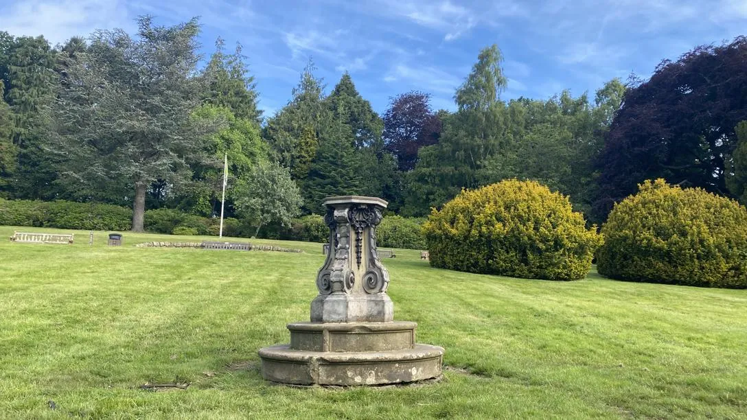 The empty sundial plinth on Heriot-Watt's lawn. A sundial pedestal in a park