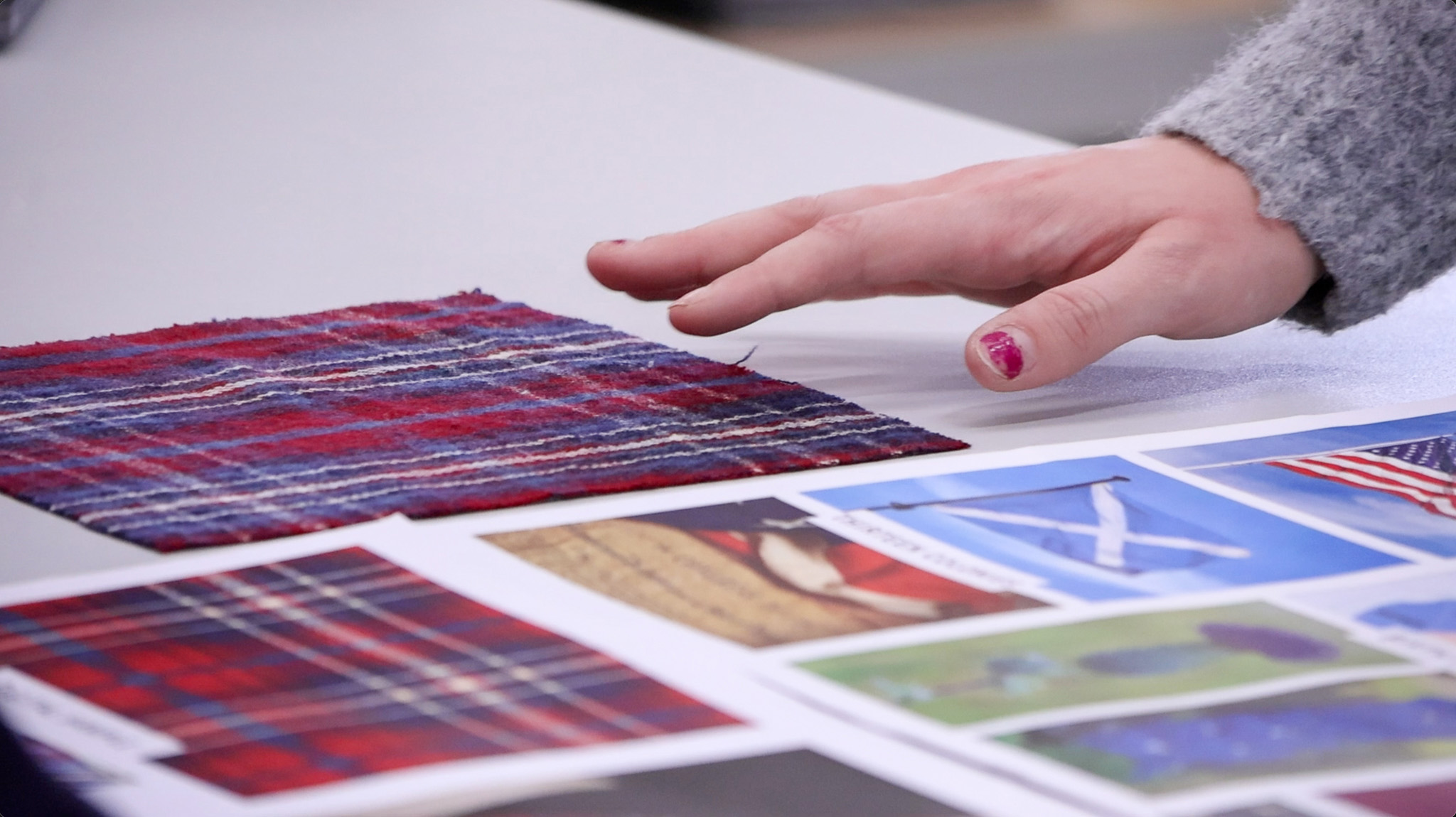 Tartan samples laid out with pictures of US and Scottish flags 