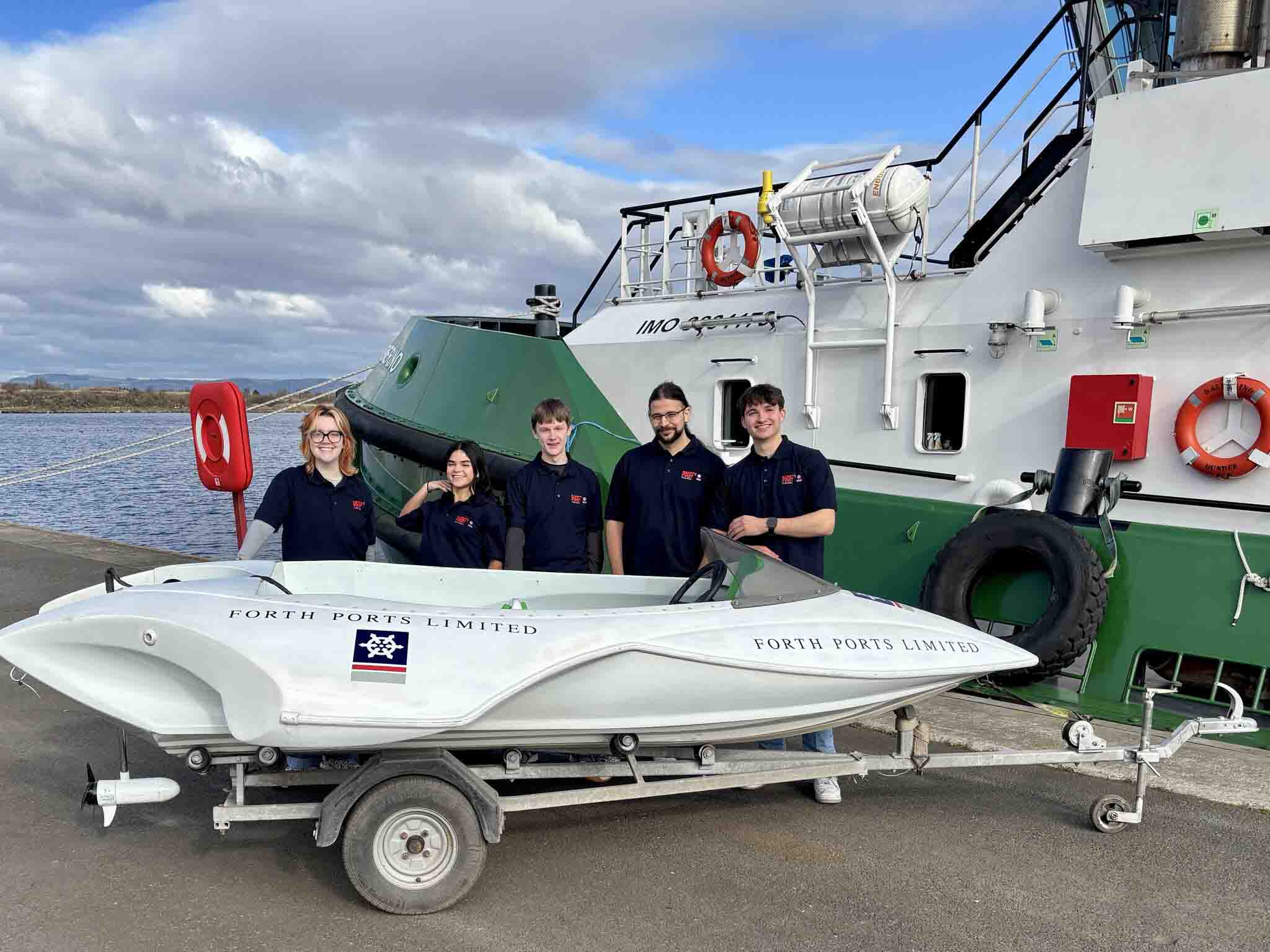 Image shows the five-strong student team standing behind the Experiment of Leith H2.