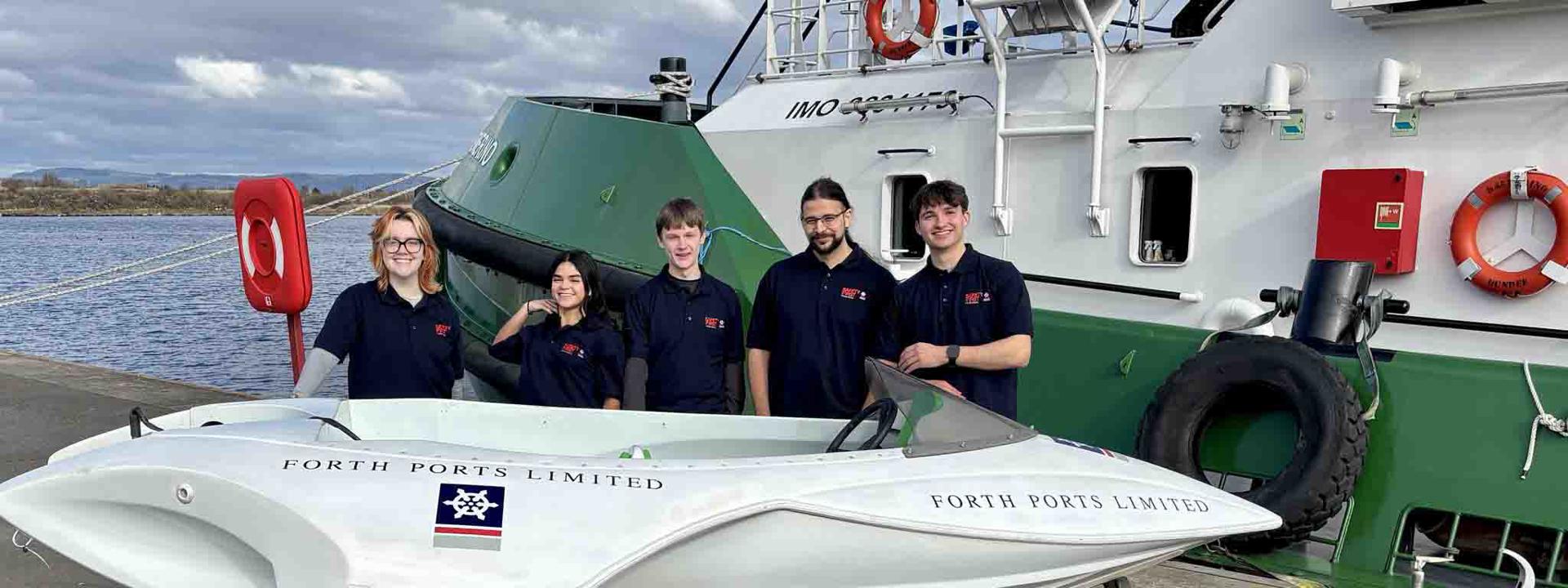Image shows the five-strong student team standing behind the Experiment of Leith H2.