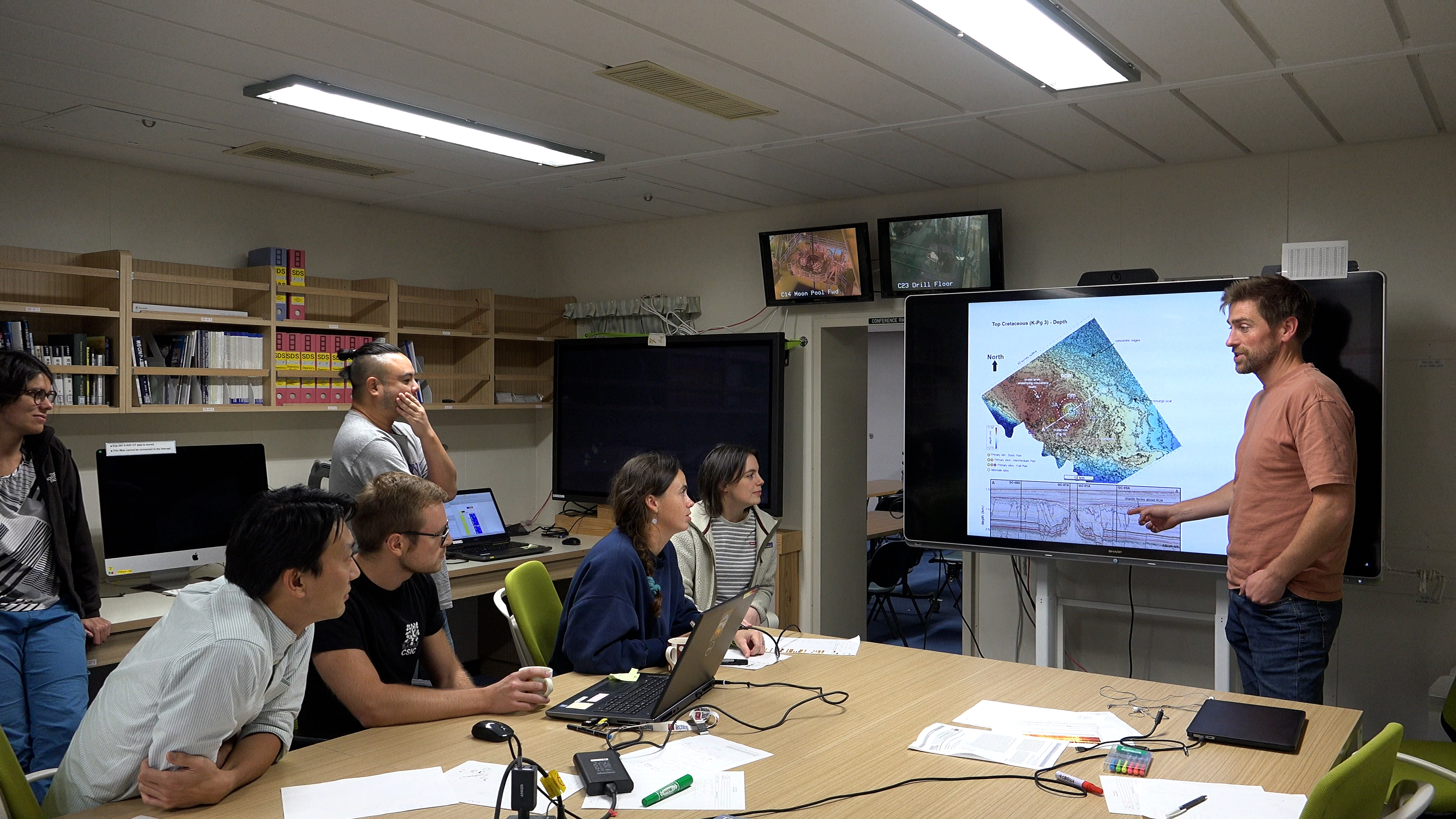 Dr Uisdean Nicholson presenting his findings to scientists on board a drilling ship.