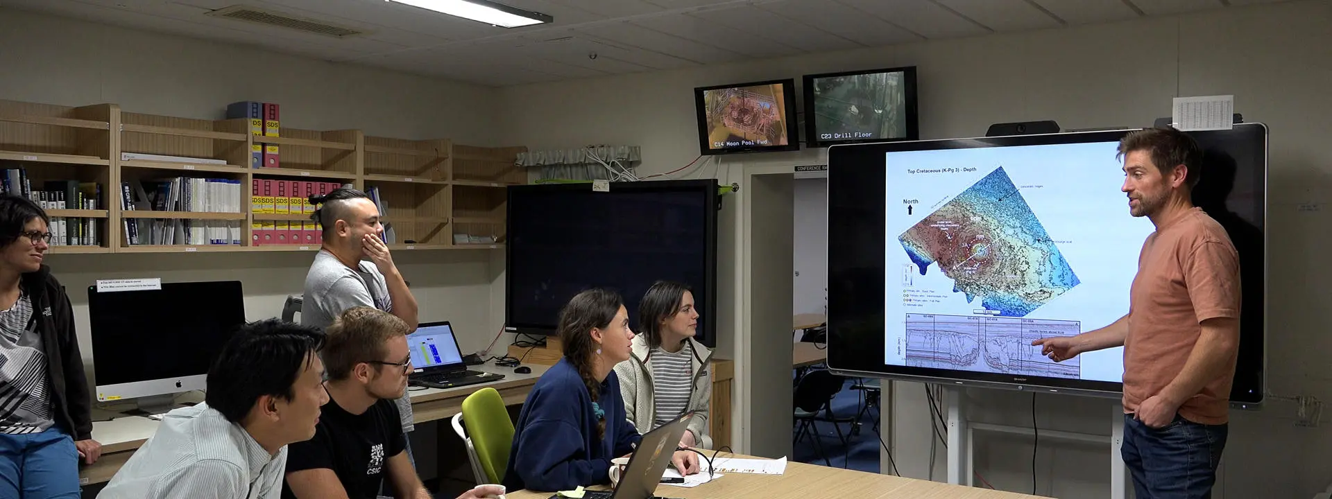 Dr Uisdean Nicholson presenting his findings to scientists on board a drilling ship.