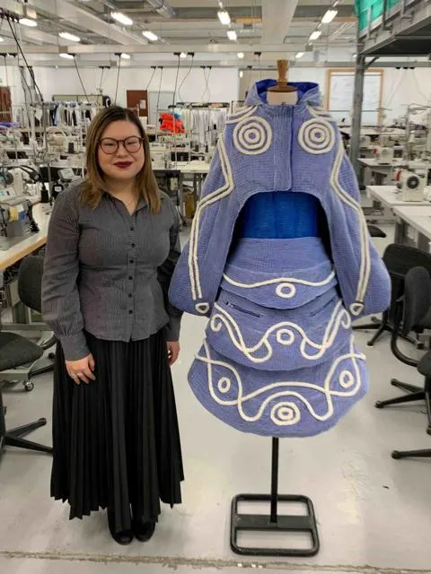 Picture shows Verna standing next to her creation. 