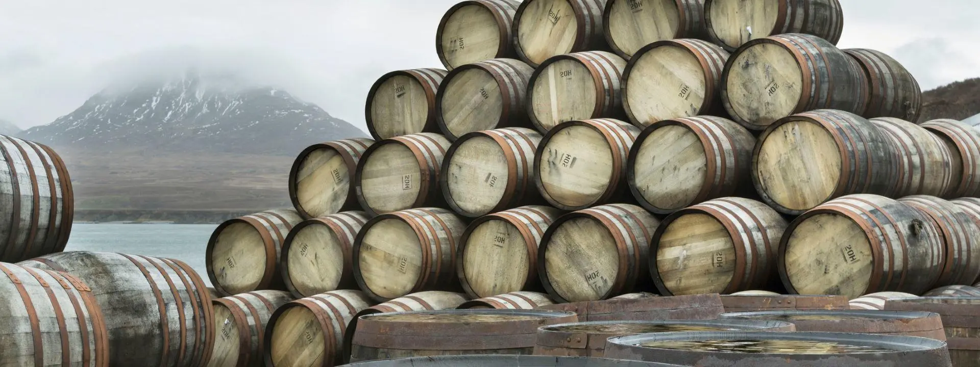 Whisky casks stacked beside Loch