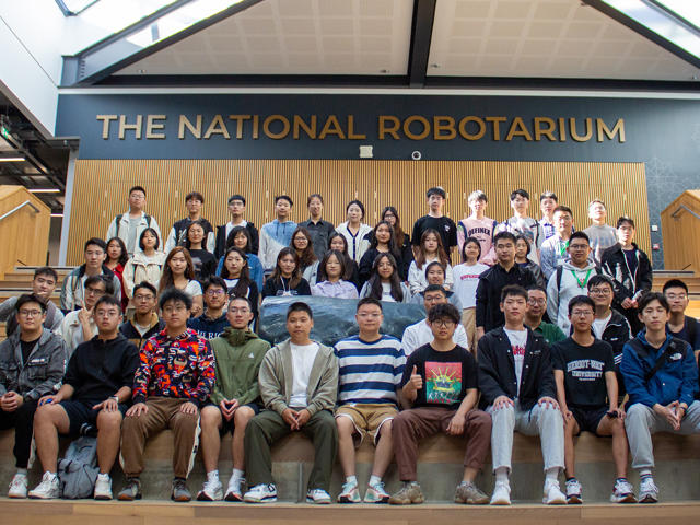 Large group of students at the steps to the National Roboratrium