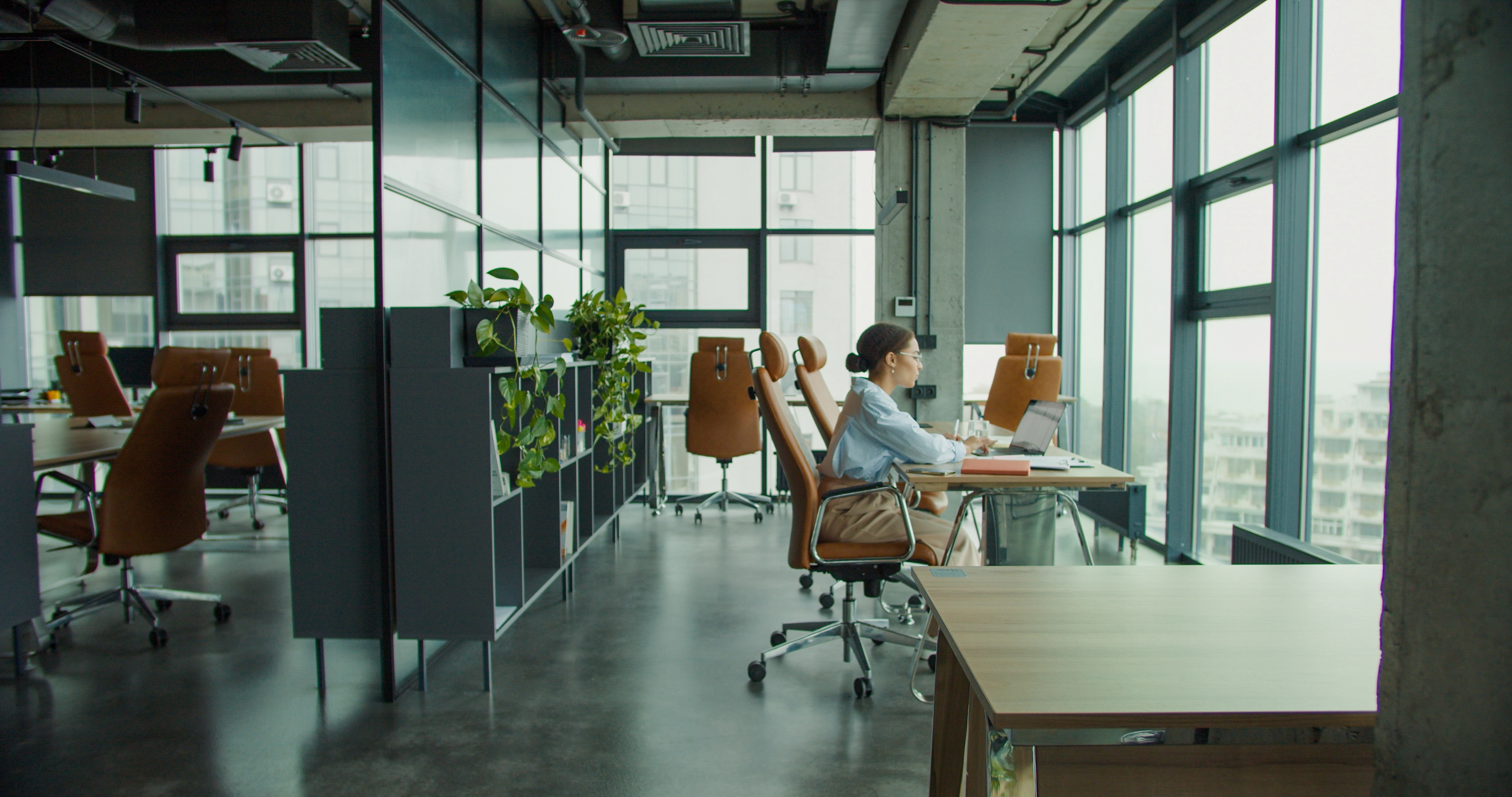 Woman sitting at a desk in an office.