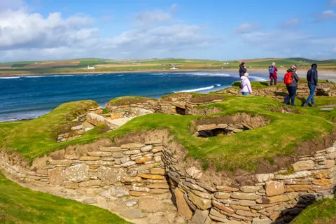 An ancient ruin sat beside a long coastline