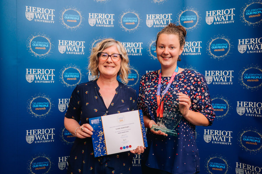 Winner of the Involve Award, Dr Lauren McWhinnie, with Prof. Jemina Napier Teo individuals smiling as they receive an award.