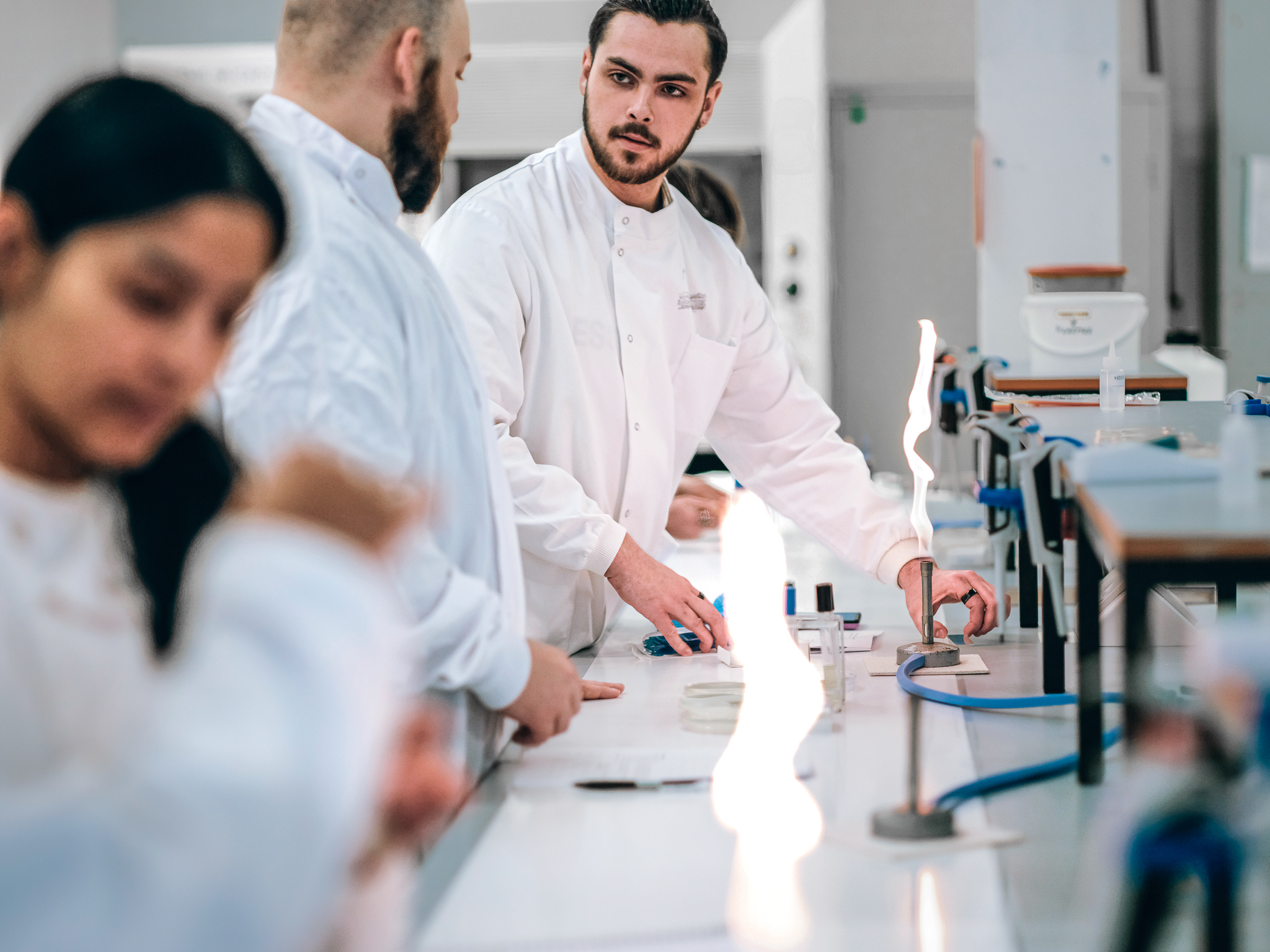 Students working with bunsen burners in a science laboratory