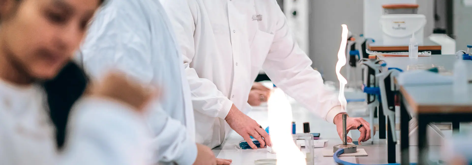 Students working with bunsen burners in a science laboratory