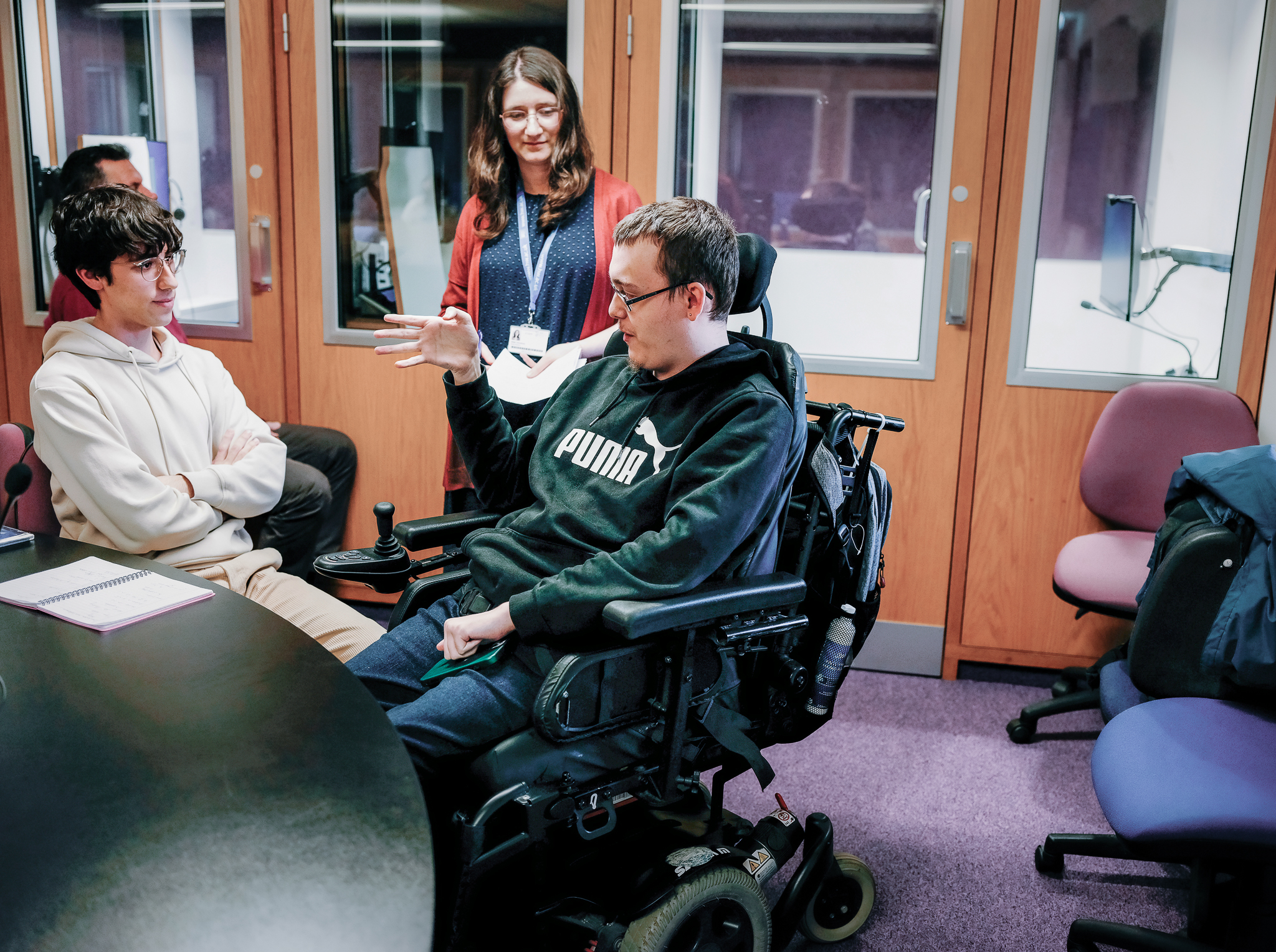 Students talking to each other in a language and interpretation booth
