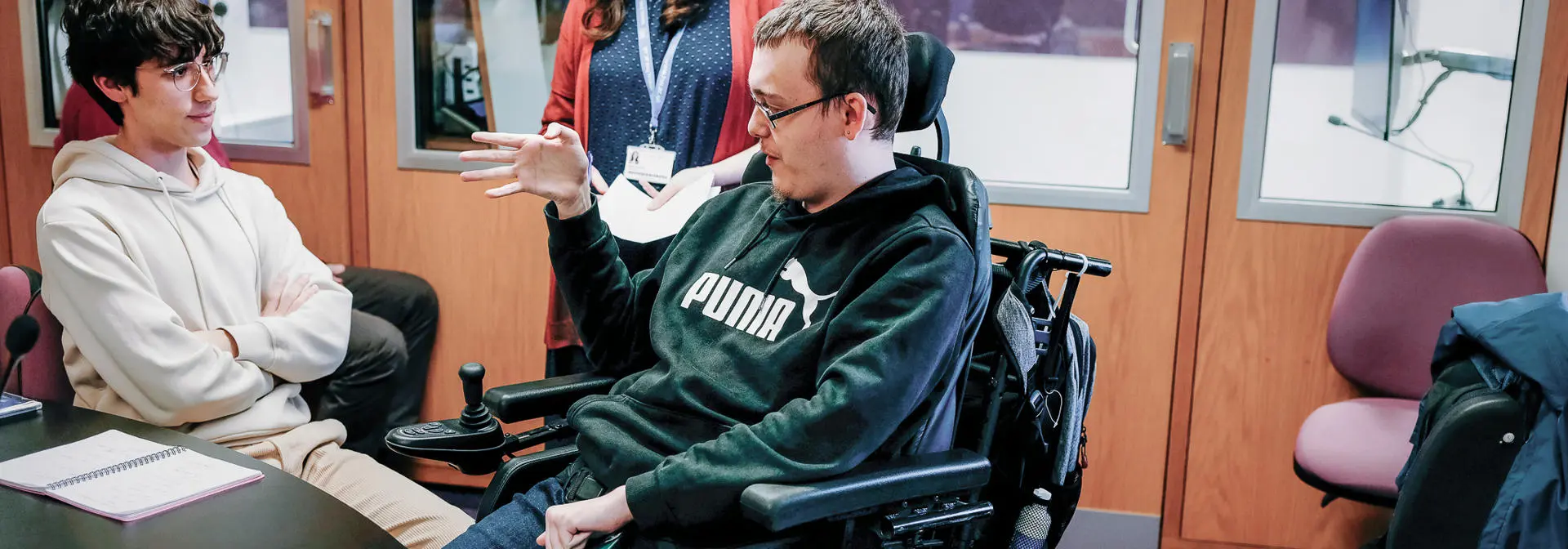 Students talking to each other in a language and interpretation booth