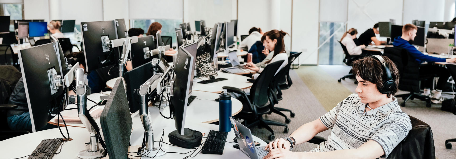 Students working on computers in a common area