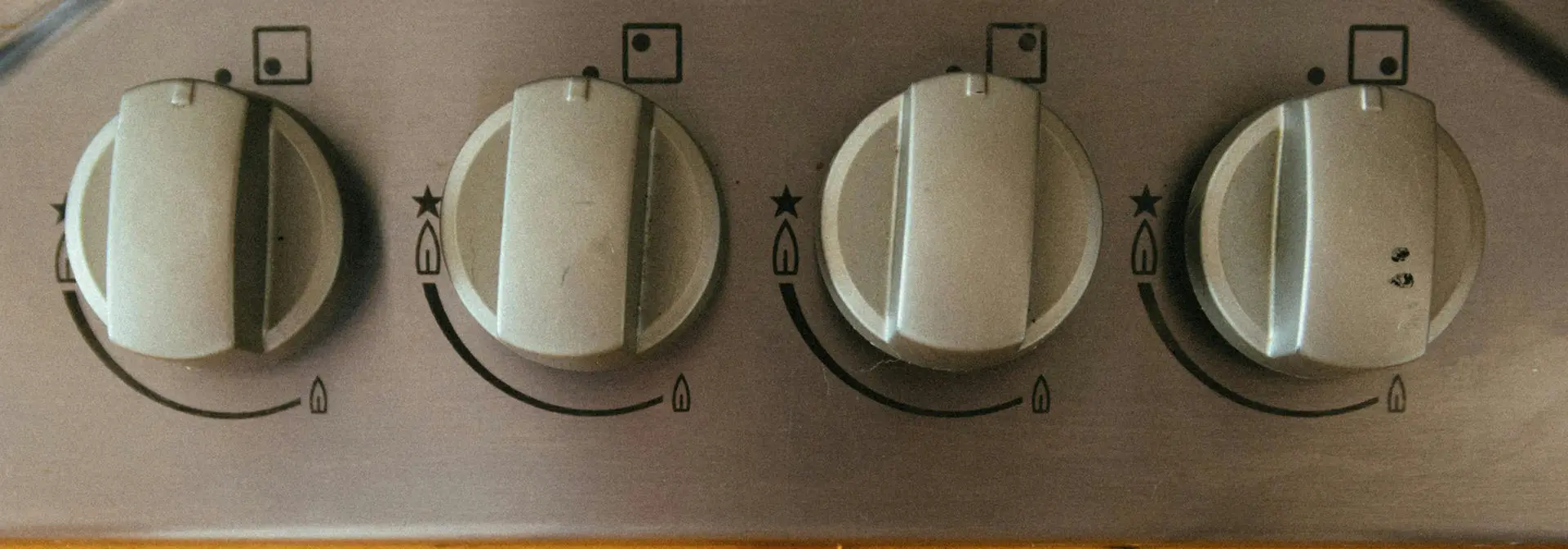 Close up of cooker control dials, all turned off.