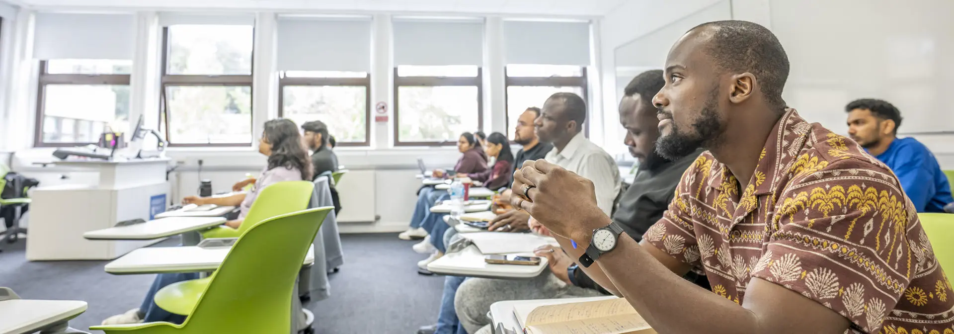 Several students seated in a classroom, focused on their lessons.