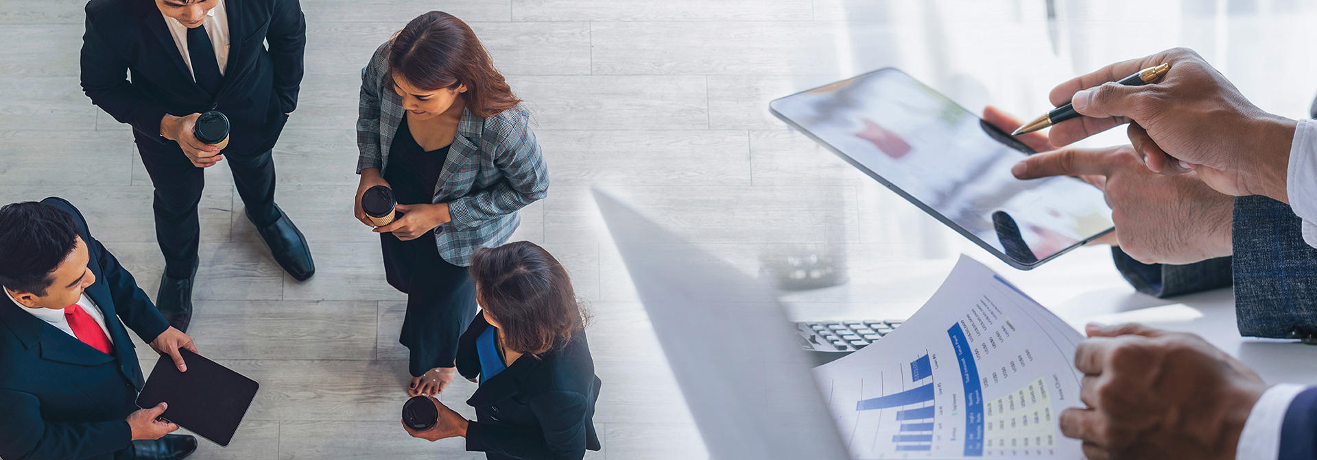 A group of business people engaged with a tablet, sharing insights and ideas in a collaborative setting.