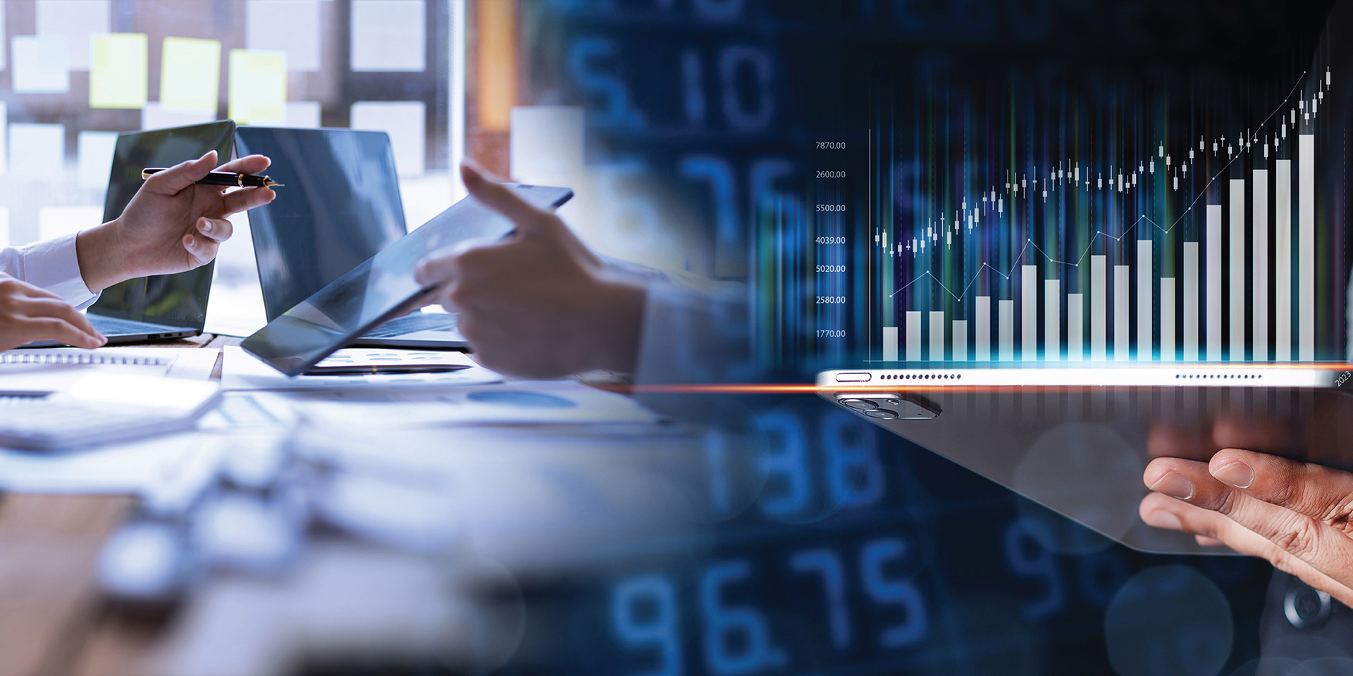 Two colleagues review a digital display featuring graphs and numerical information.
