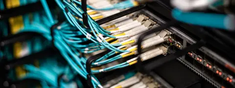 Blue computer cables plugged into a circuit board.