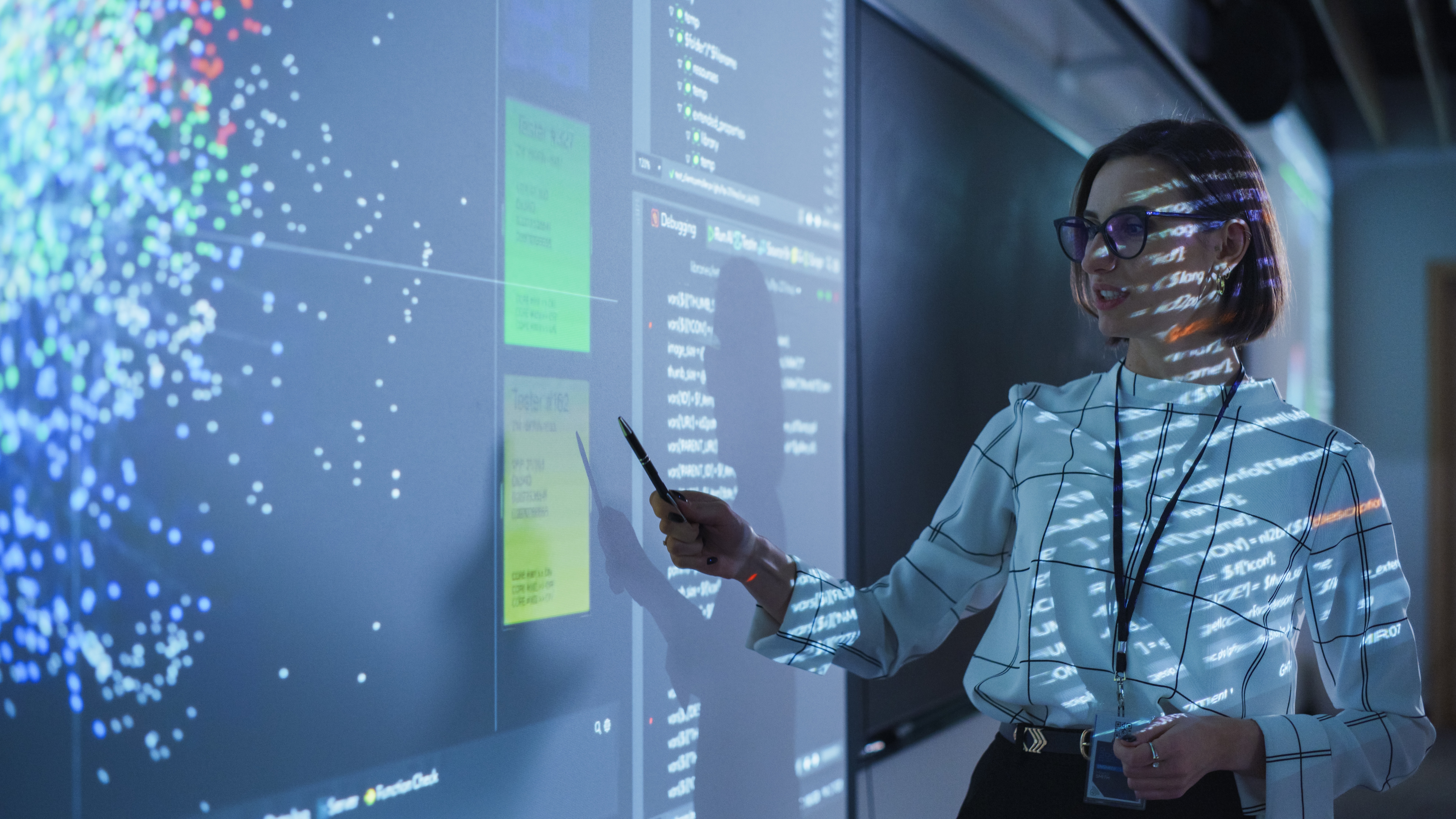 Female data scientist showcasing their data visualisation on a projector