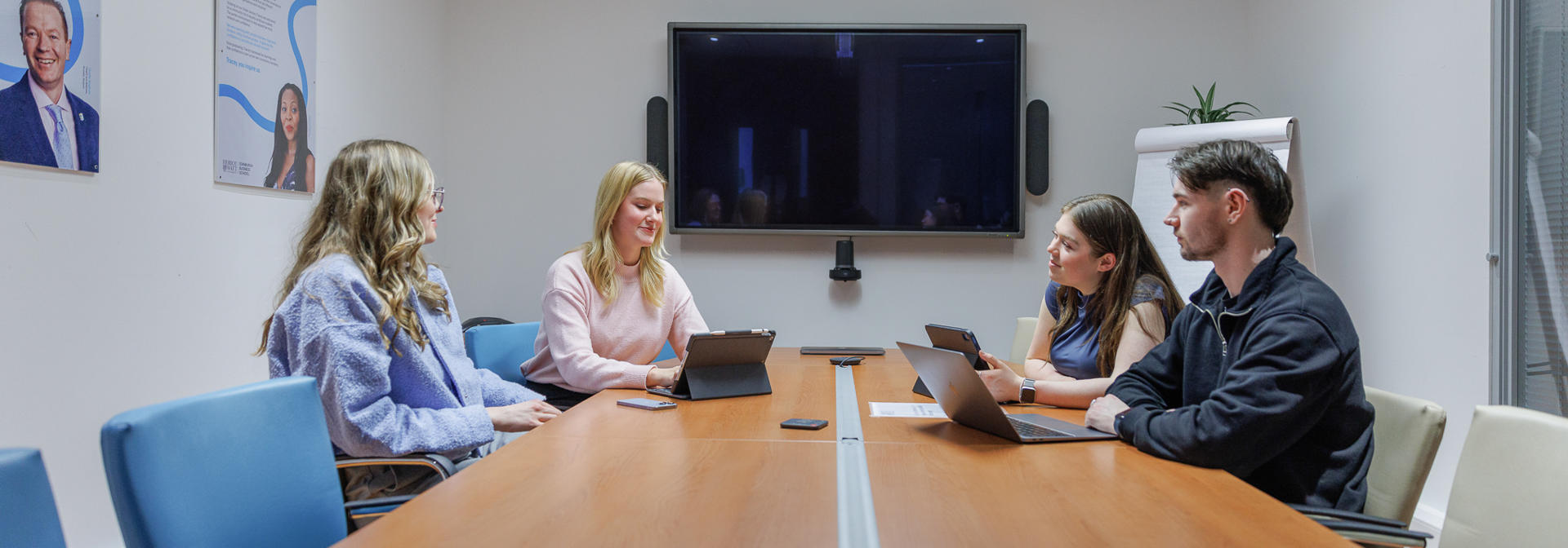 Students working together in a meeting room
