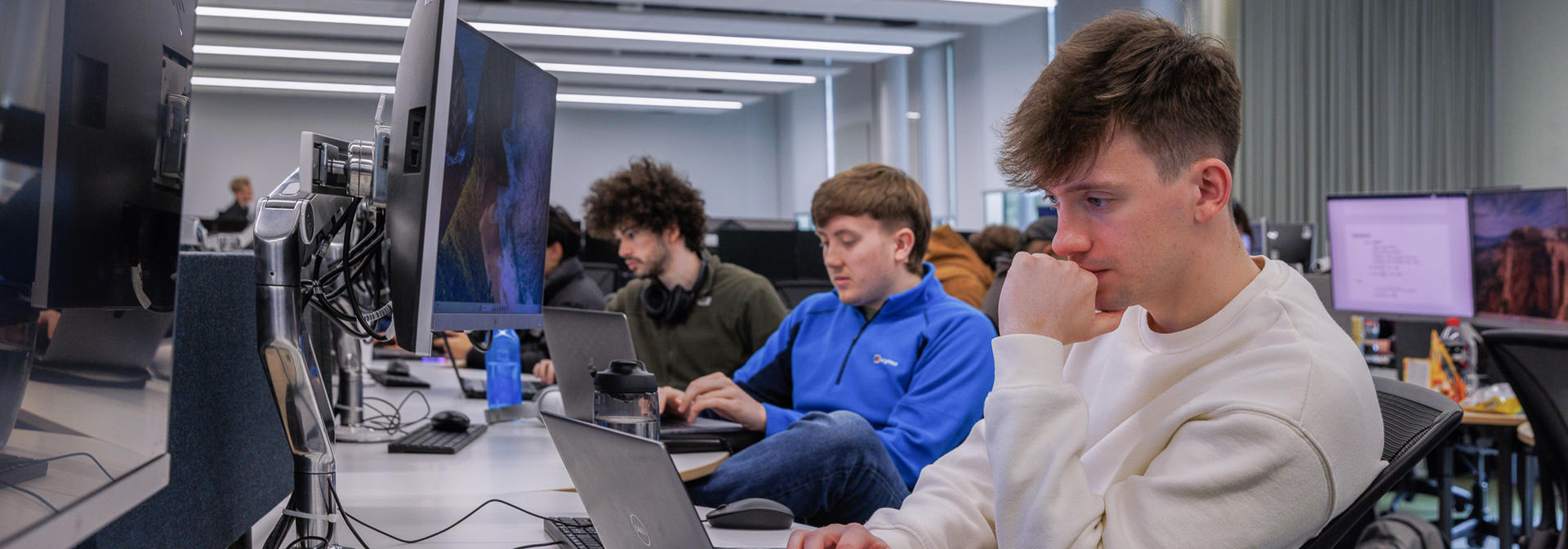 Students working on laptops in common area
