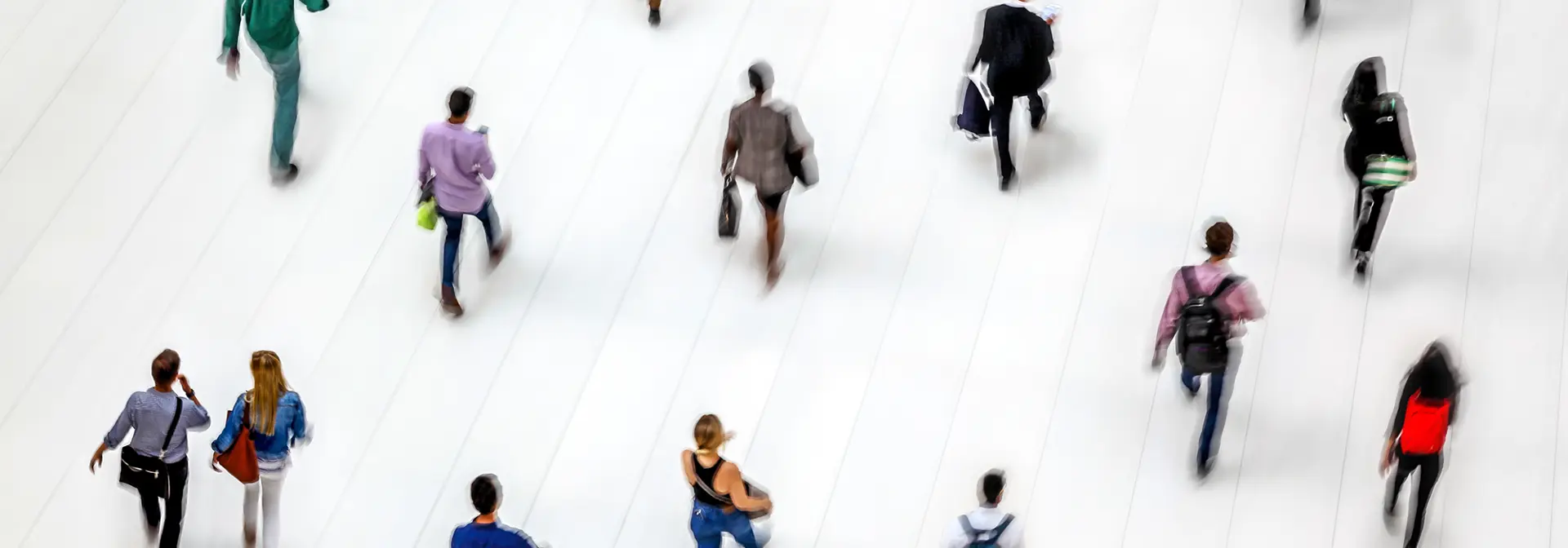 People walking in a white-tiled hall