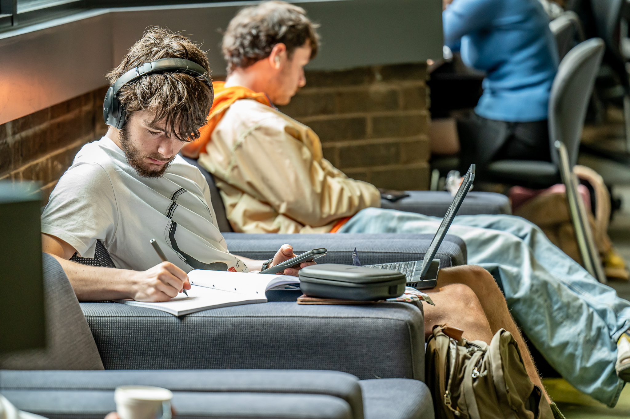 Students sitting down and working in a common area