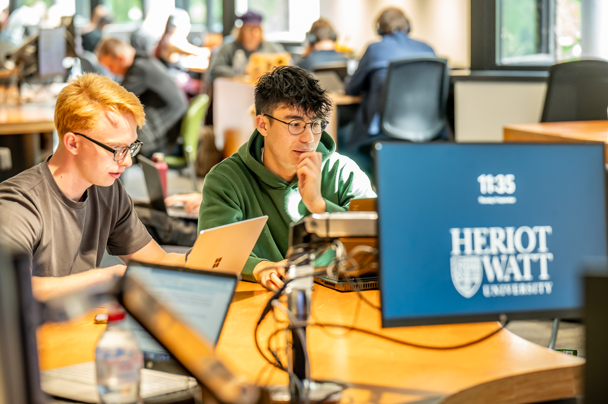 Students working on computers in a common area