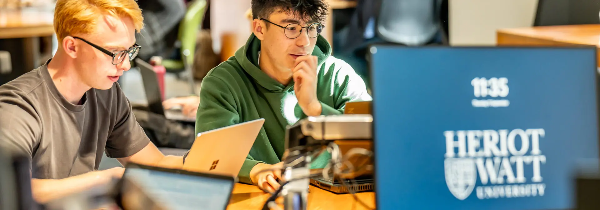 Students working on computers in a common area