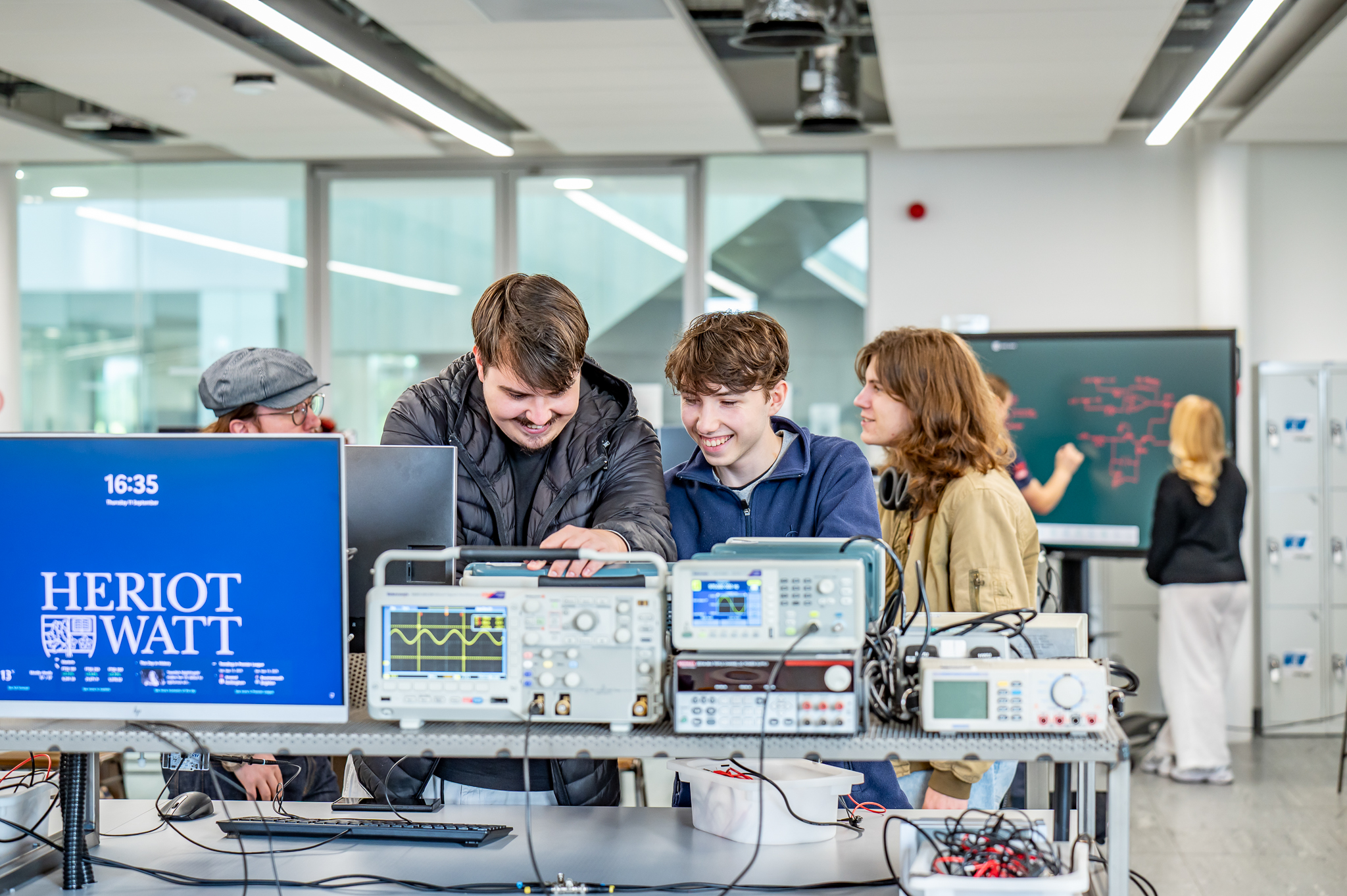 Students working on electrical equipment in a lab
