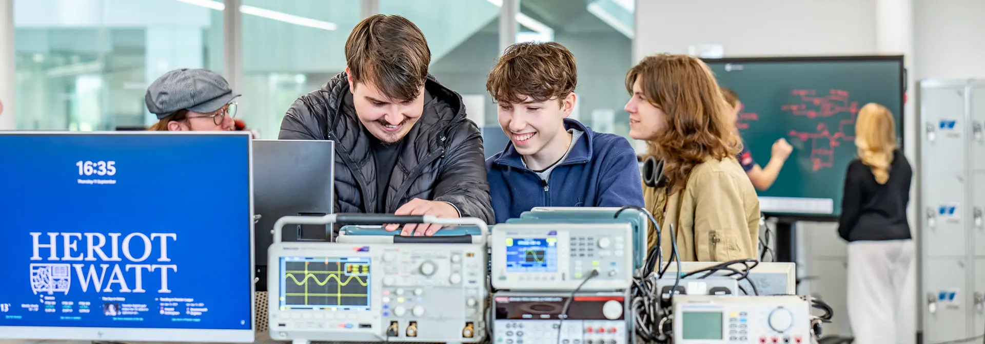 Students working on electrical equipment in a lab