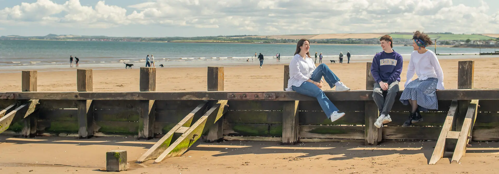 Students talking on a beach