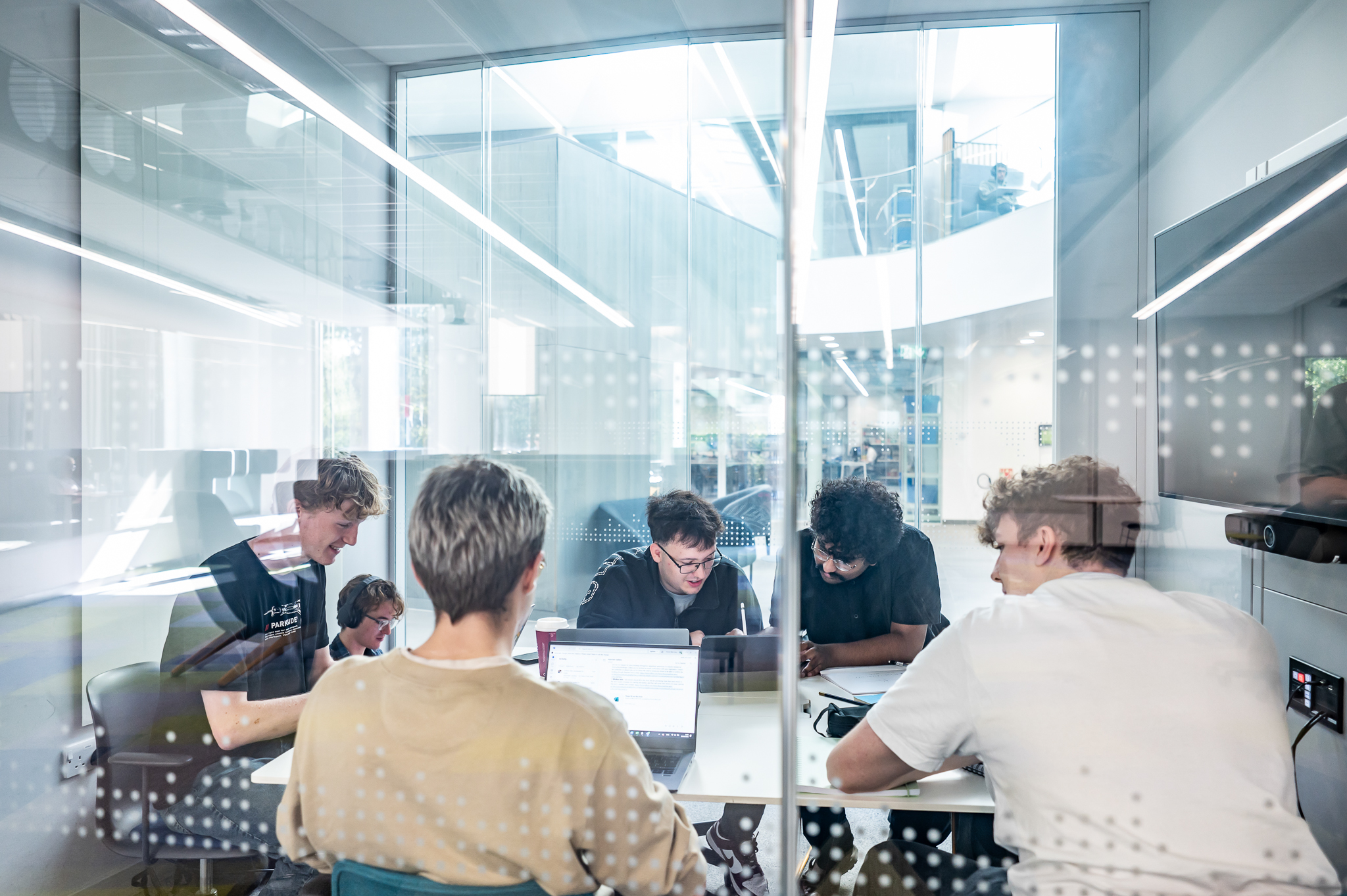 Students sitting and working together in a meeting room