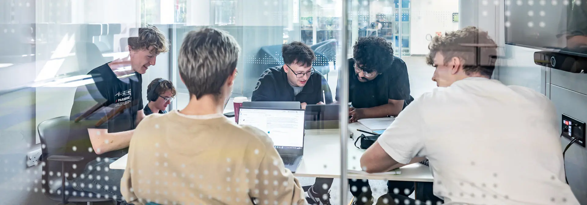 Students sitting and working together in a meeting room